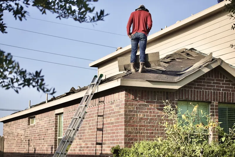 Professional roofer working on a residential roof in West Minnehaha